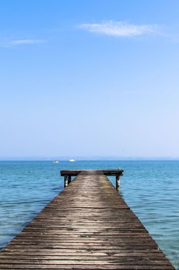 Scenic view of jetty in sea against clear sky