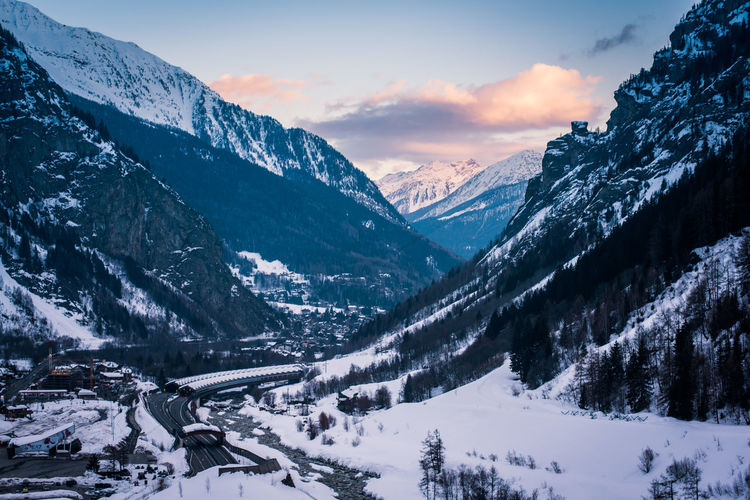 Aerial view of road passing through snow covered land during winter