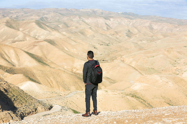 Rear view of man standing on mountain
