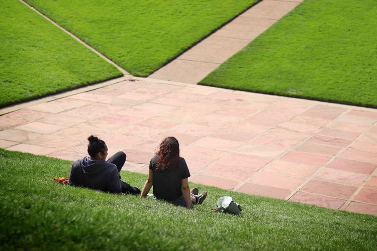 High angle view of people sitting on grass