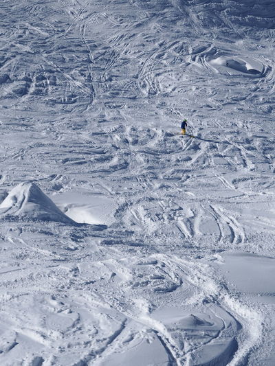 Distant view of person skiing in snow