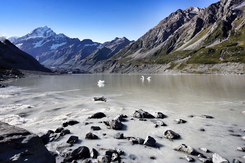 Lake with ice crystals against rocky mountains