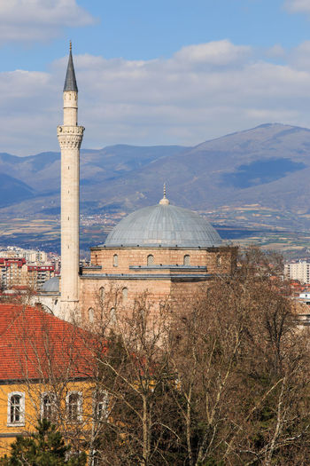 Mustafa pasha mosque by mountains against cloudy sky