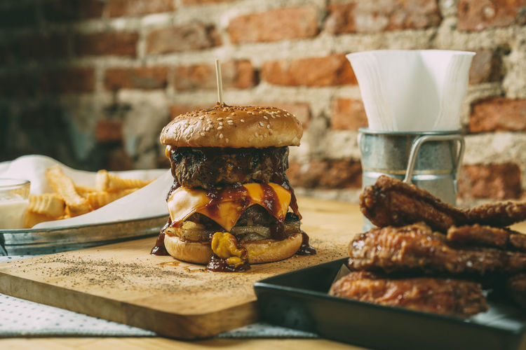 Close-up of burger with meat and french fries on table