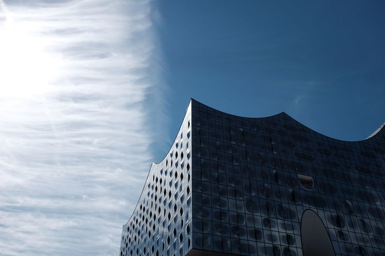 Low angle view of modern office building against sky