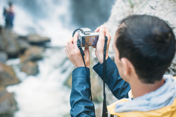 High angle view of man photographing from camera