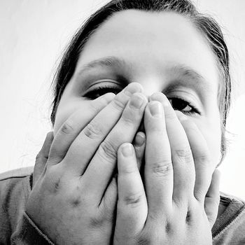 Close-up a of girl covering face with hands