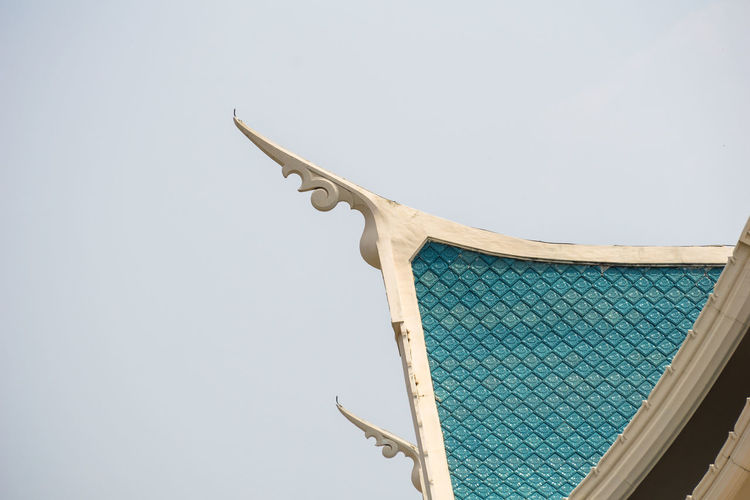 Low angle view of sculpture on building against clear sky
