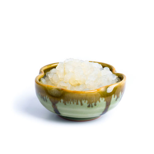 Close-up of ice cream in bowl over white background