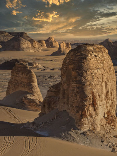 Scenic view of desert against sky during sunset