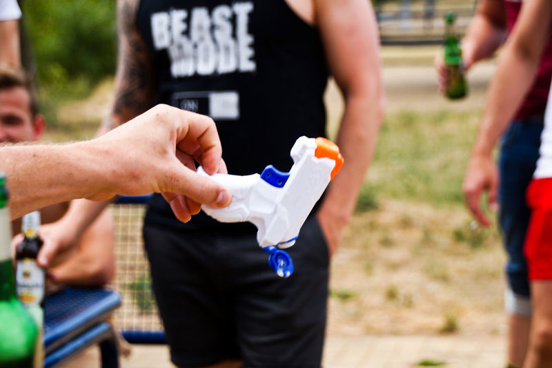 Cropped hand holding squirt gun