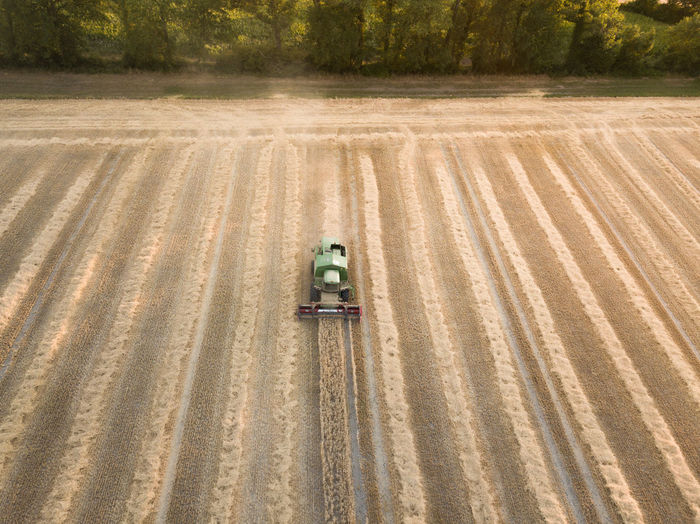 Aerial view of combine harvester on agriculture landscape