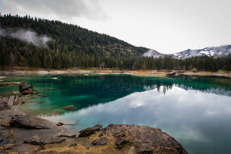 Scenic view of lake and mountains against sky