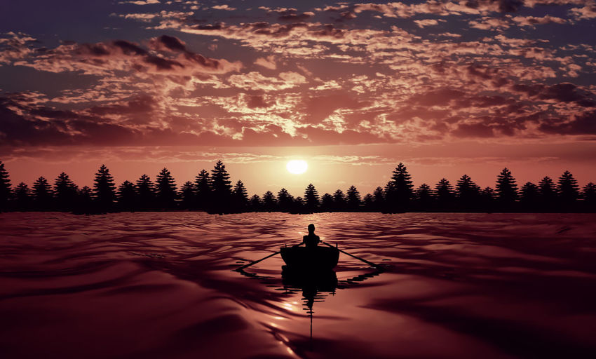 Silhouette man on boat against sky during sunset