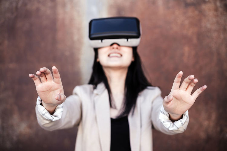 Chinese businesswoman using virtual reality headset. selective focus on hands. technology