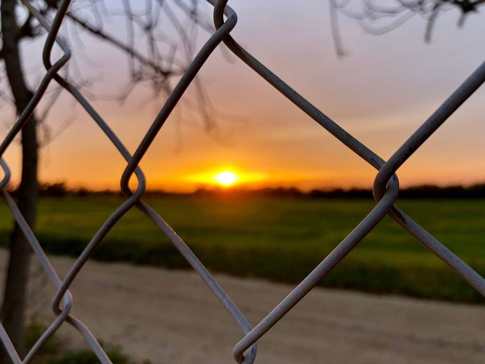 Sunset through fence