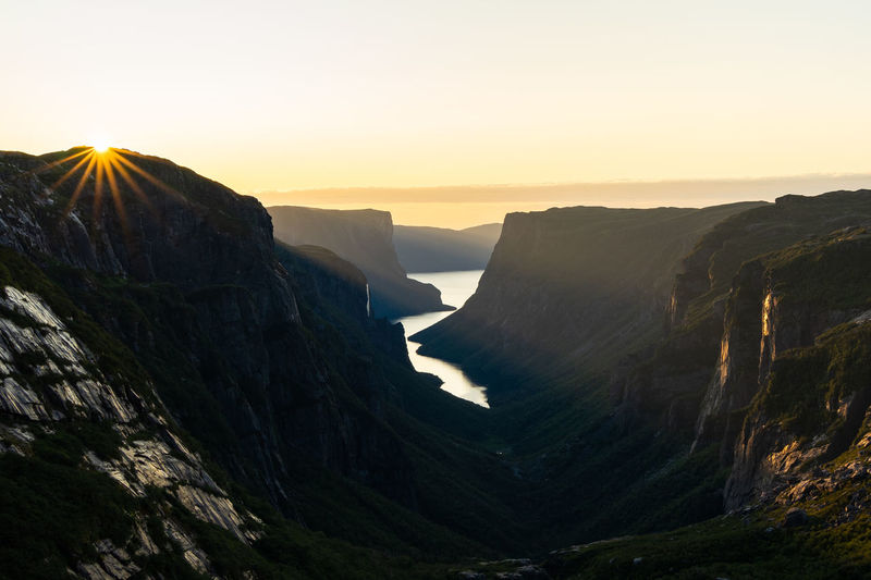 Scenic view of sea against clear sky during sunset in gros morne national park, newfoundland, canada