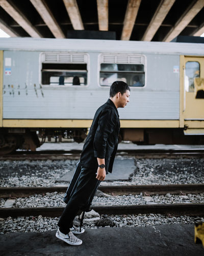 Side view of man in train at railroad station in yogyakarta jembatan janti