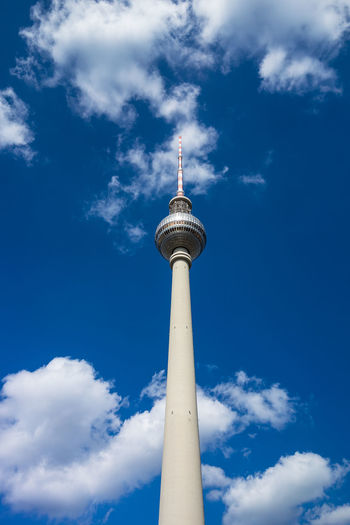 Low angle view of fernsehturm against sky during sunny day