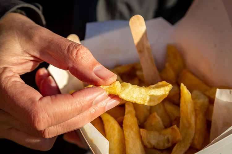 Cropped image of hand holding food