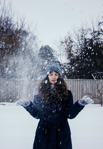 Woman standing in snow