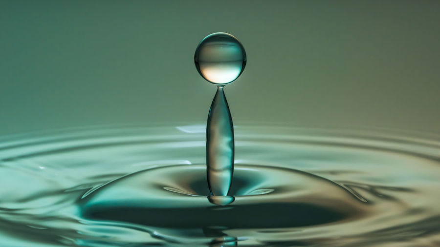 Close-up of green drop in water