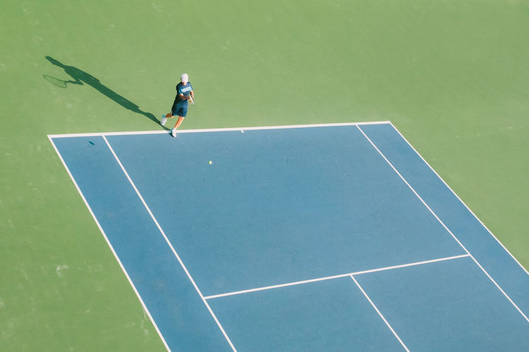 Full length of boy playing tennis