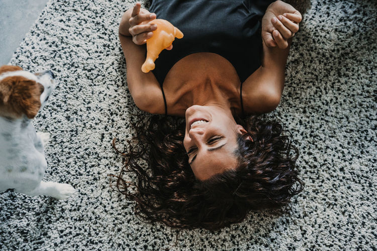 High angle view of woman lying on bed