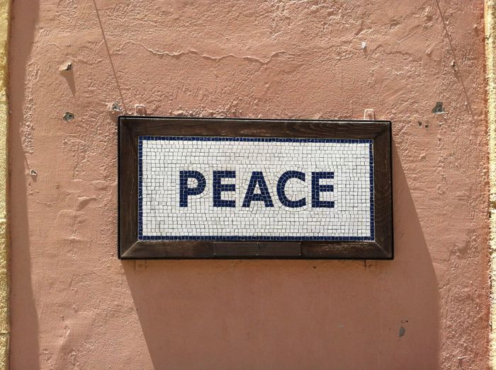 Close-up of peace sign on wall