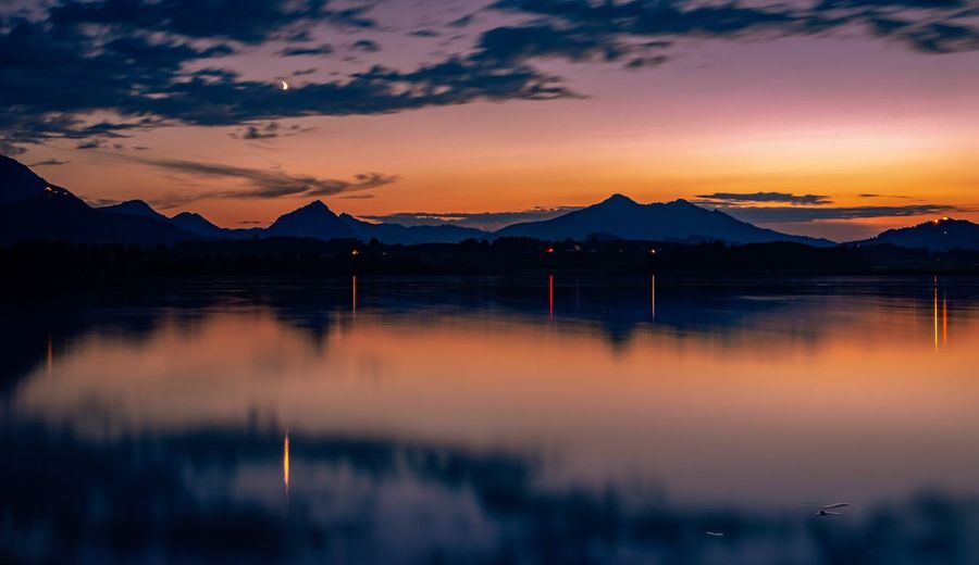 Scenic view of lake against orange sky