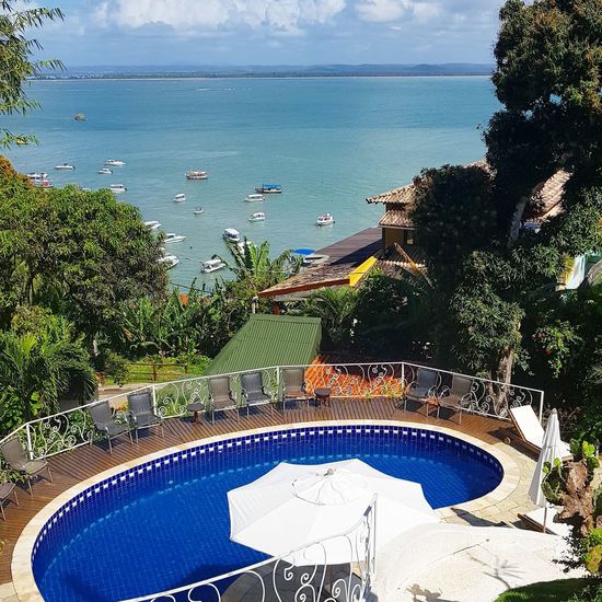 High angle view of swimming pool by sea against sky