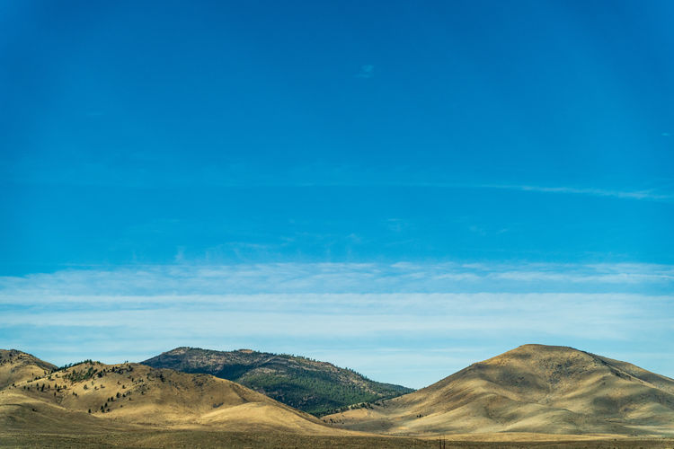 Beautiful arid rolling hills landscape in northern california against blue sky