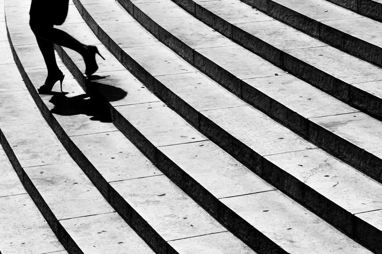 Low section of woman moving down on steps