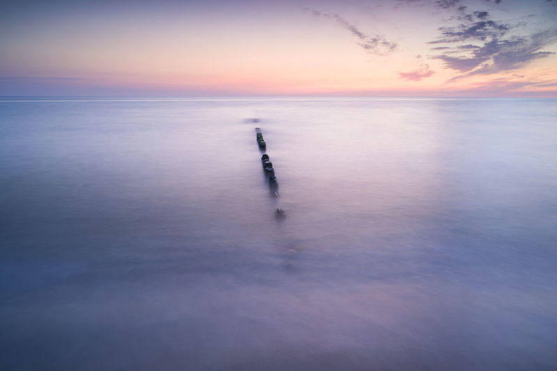 Long exposure of sea against sky during sunset