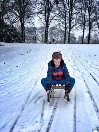 Boy on sled in winter