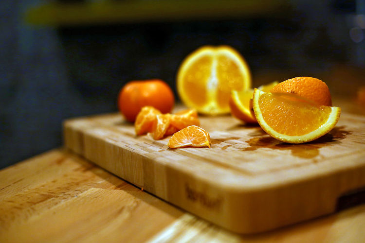 Close-up of orange slices on cutting board