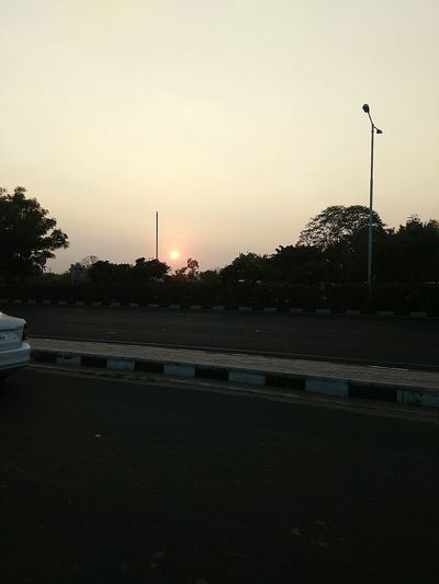 View of street light against sky at sunset