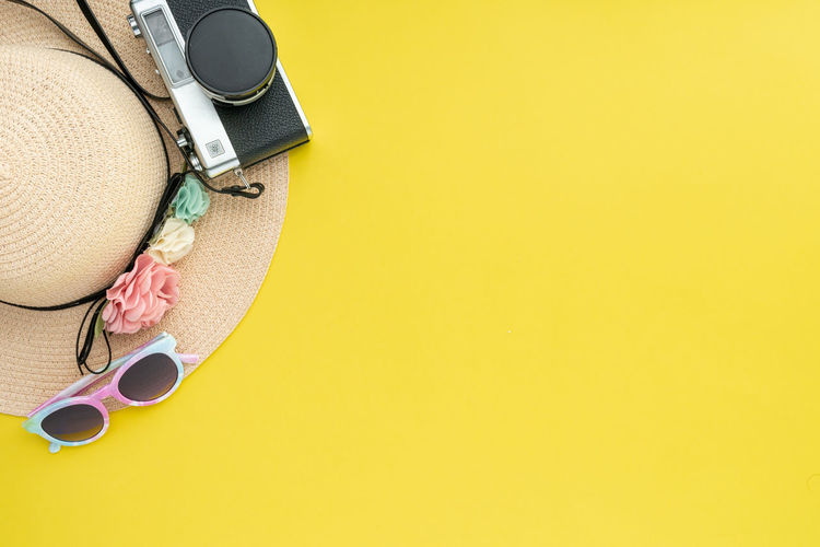 High angle view of headphones on yellow background