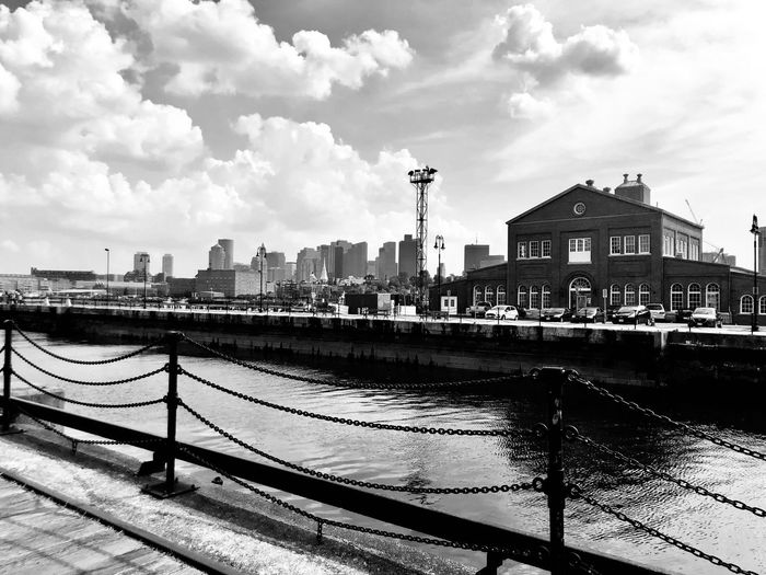 River by buildings against sky in city