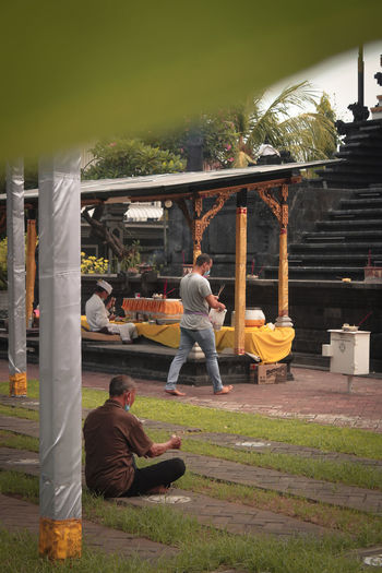 Rear view of men sitting at park