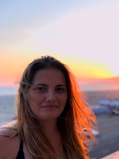 Portrait of woman against sky during sunset