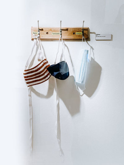 Clothes drying on clothesline against white background