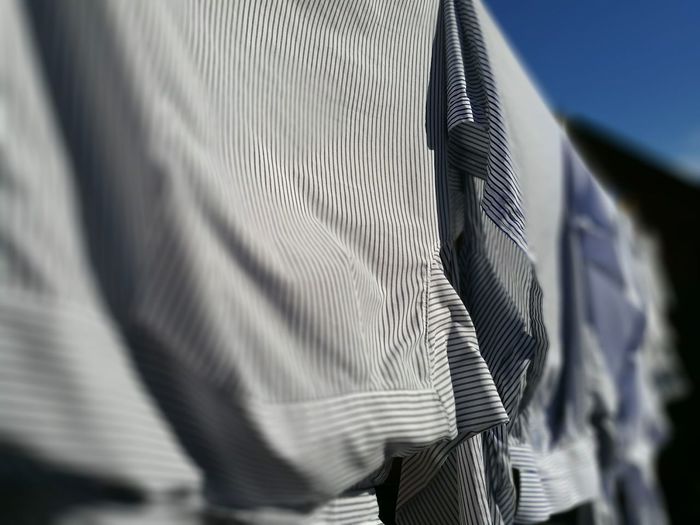 Close-up of shirts hanging outdoors