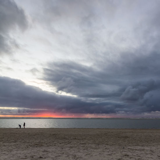 Scenic view of sea against dramatic sky