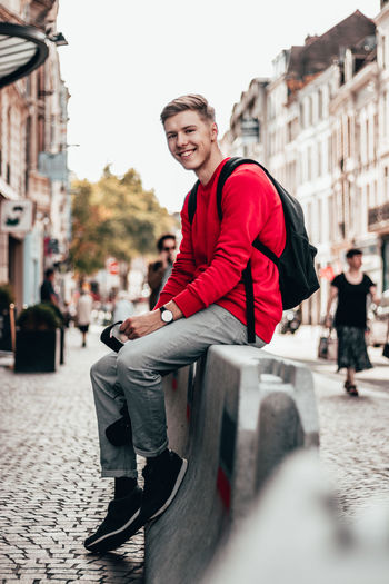 Portrait of smiling young man on street in city
