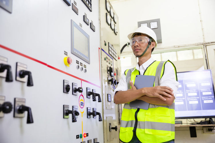 Electrician engineer work at relay protection system. bay control unit. medium voltage switchgear.