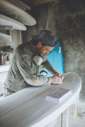 Surfboard shaper refining a new design