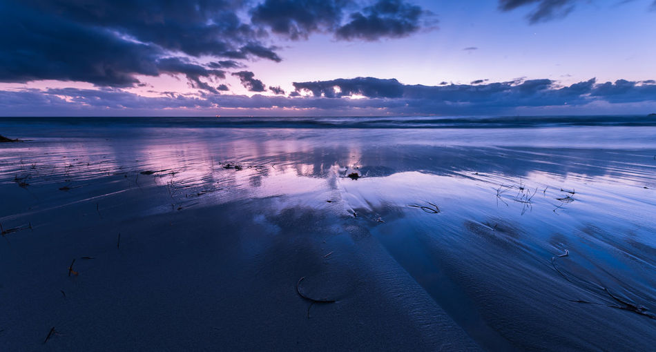 Scenic view of sea against sky at sunset