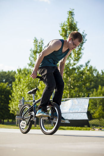 Side view of person riding bicycle
