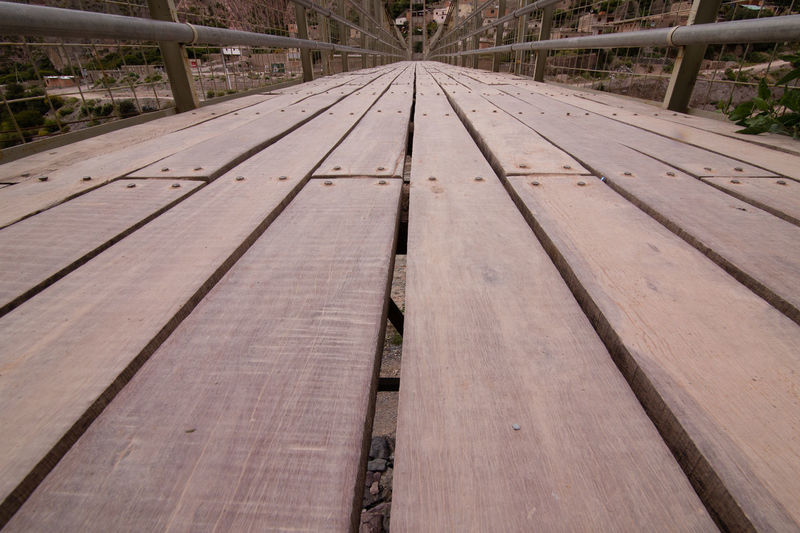 View of empty bench on bridge